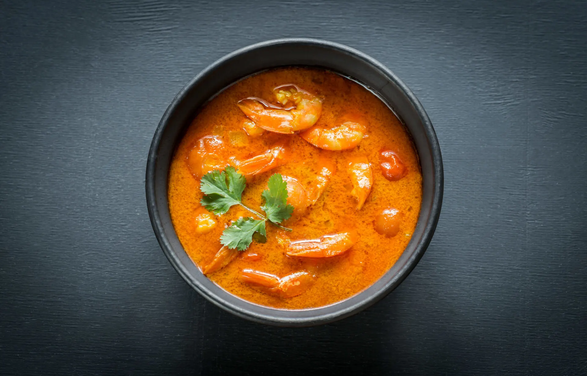 Bowl of thai yellow curry with seafood