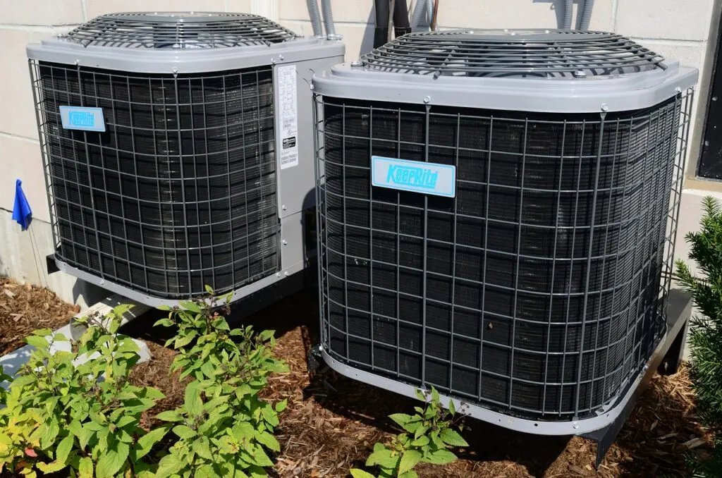 Two HVAC units outside a house. One of our biggest tips for a Better Home Environment is taking care of your HVAC.