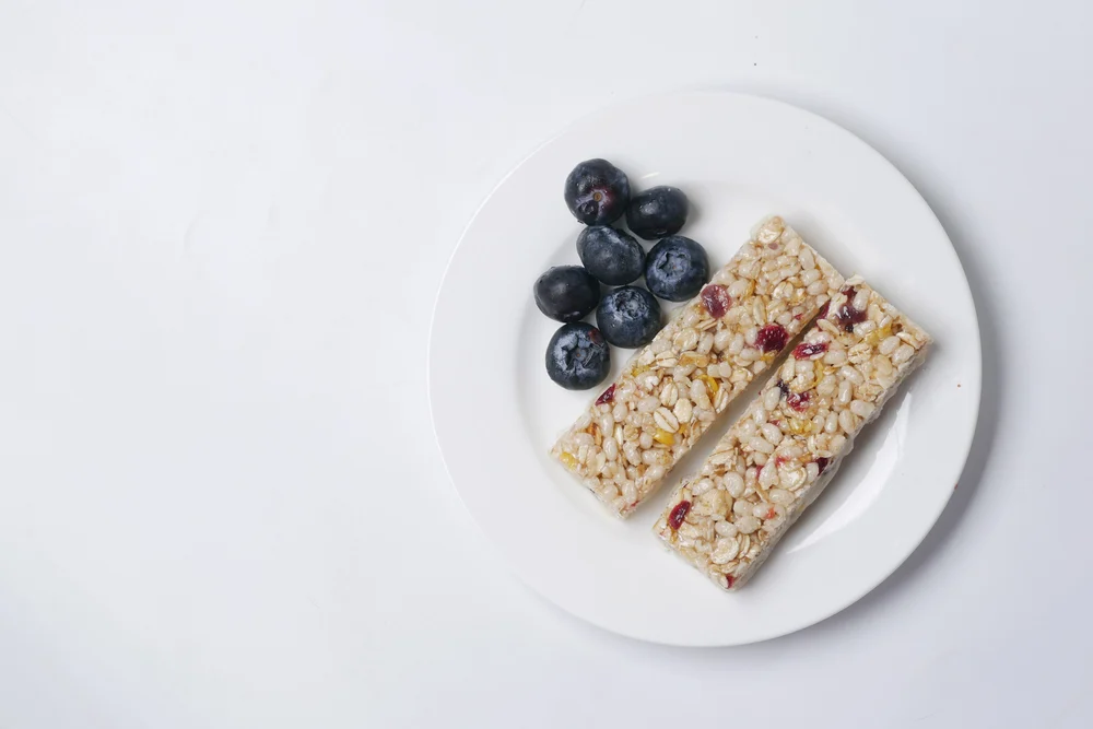 blackberry oat protein bars on white background ,
