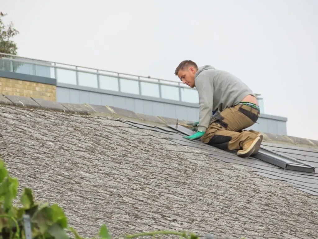 A person fixing the roof
