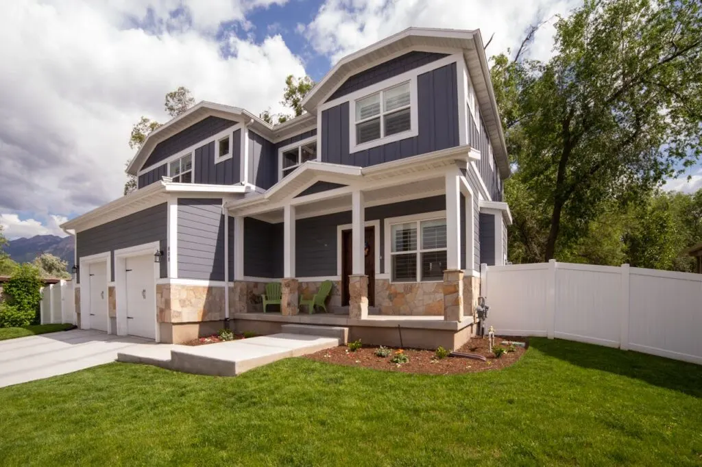 Building a custom home like this grey and white one can be a fun but challenging decision
