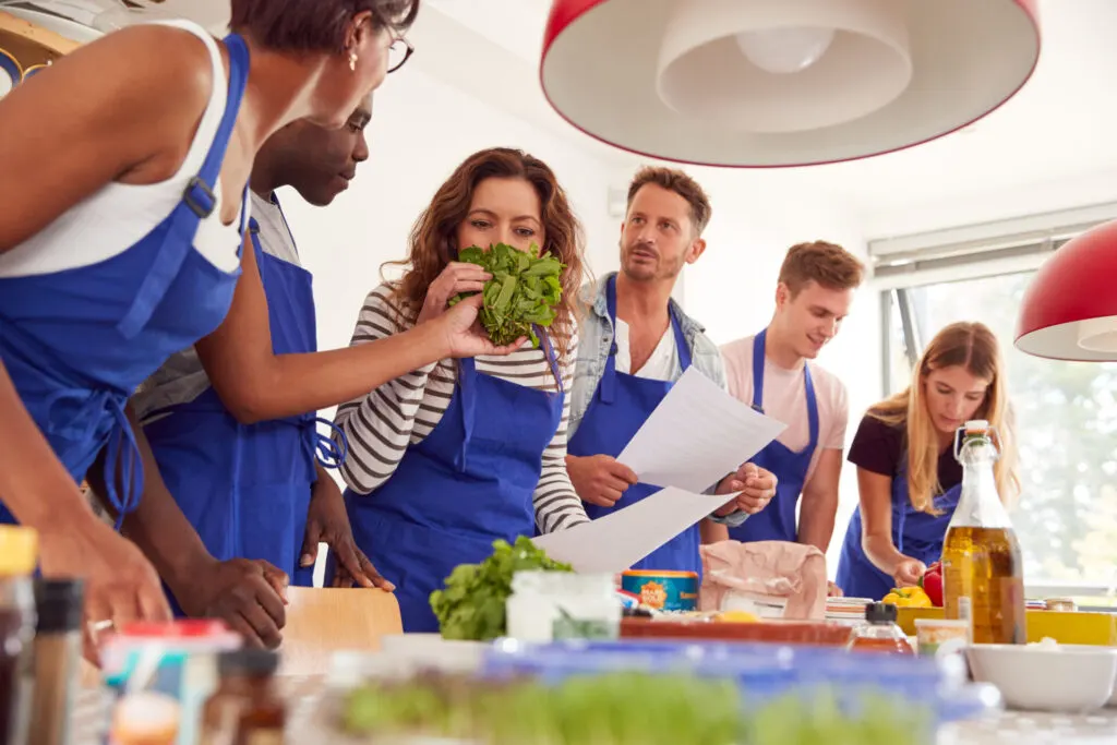 Male and female students in a cookery cooking class