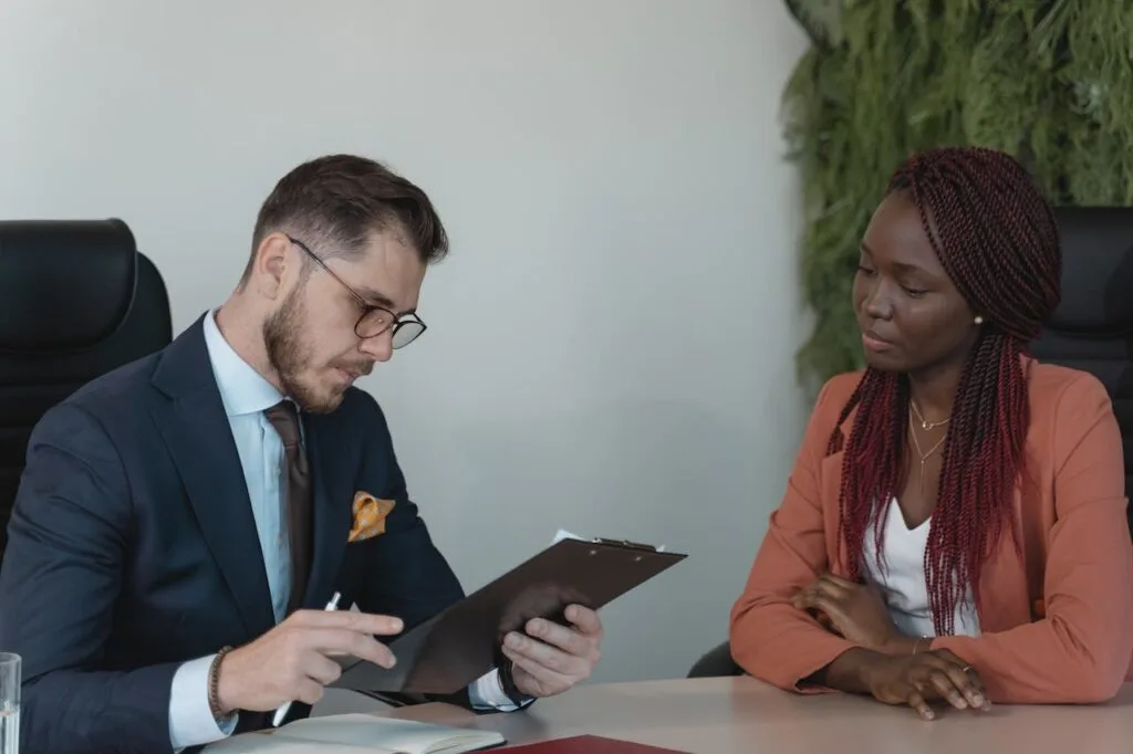 A man and woman going over employment law strategies while sitting at a table