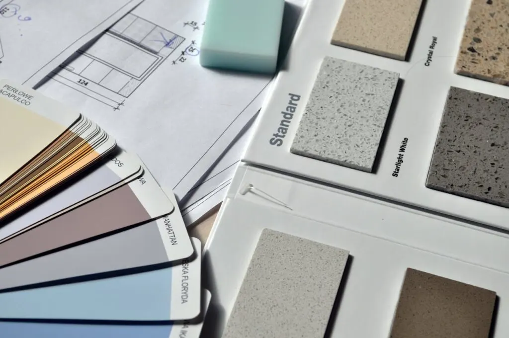 Paint color swatches and tile samples on a table