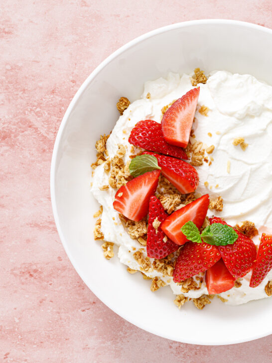Yogurt with strawberry. Plain white greek yogurt with fresh berries and granola. Healthy food, breakfast. Top view