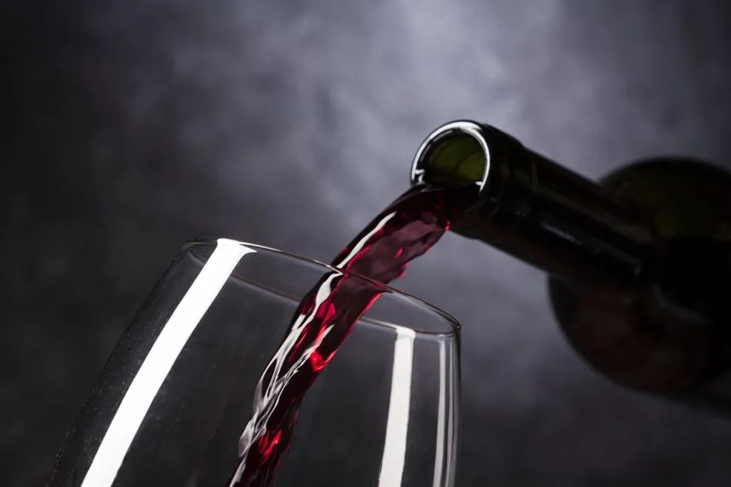 Pouring red wine in a glass