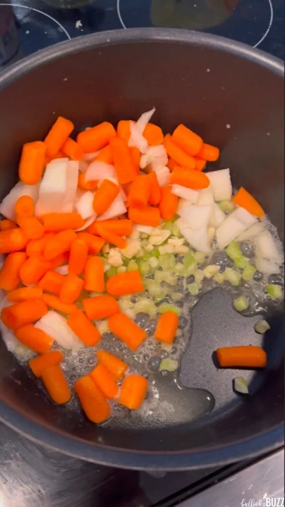 Sauteing the carrots, garlic and onion in butter