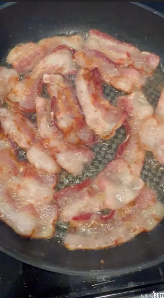 Cooking bacon in a large skillet to later add to the Cheese Tortellini Soup with Bacon and Spinach