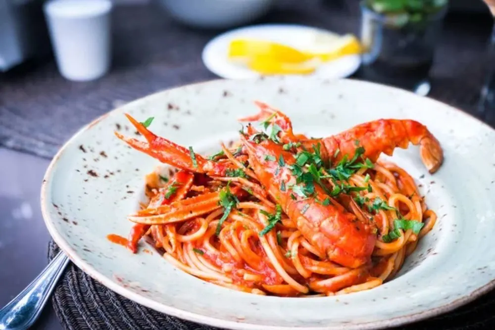 Delicious italian spaghetti with lobster, tomatoes