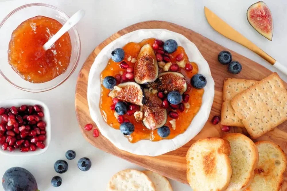 Baked brie appetizer topped with figs and jam