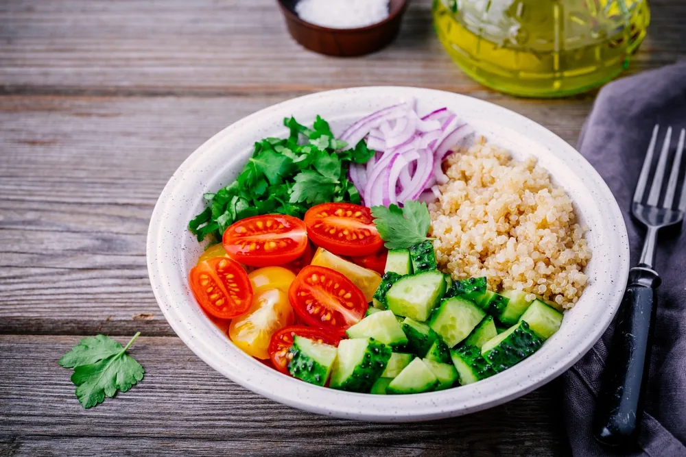 Healthy detox Quinoa Tabbouleh Salad bowl with fresh cucumbers, tomatoes and red onions