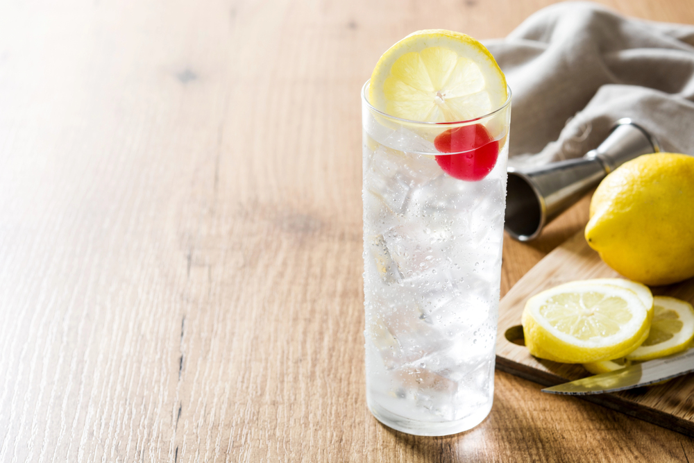 Classic Tom Collins cocktail on wooden table.