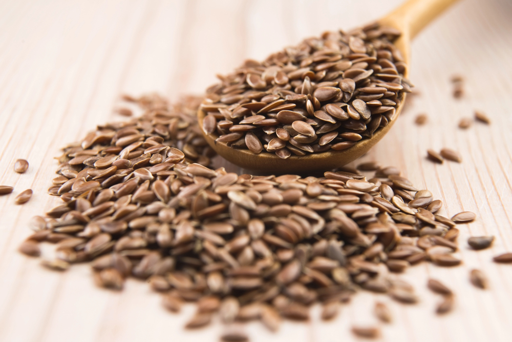 Wooden spoon with Flaxseeds — Photo