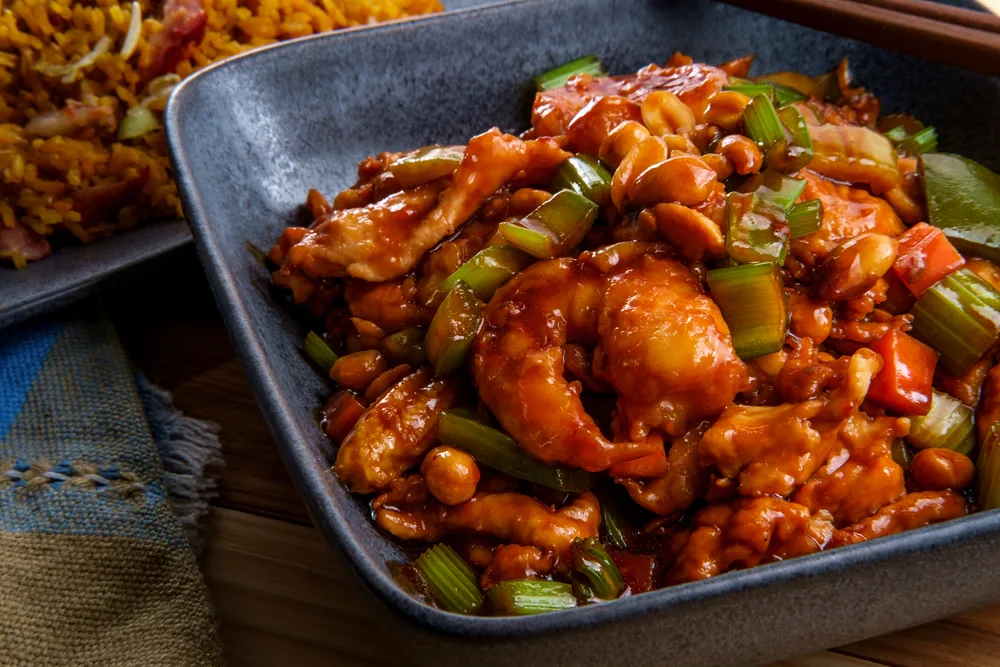 Takeout Chinese kung pao chicken and shrimp with peanuts and side of pork fried rice