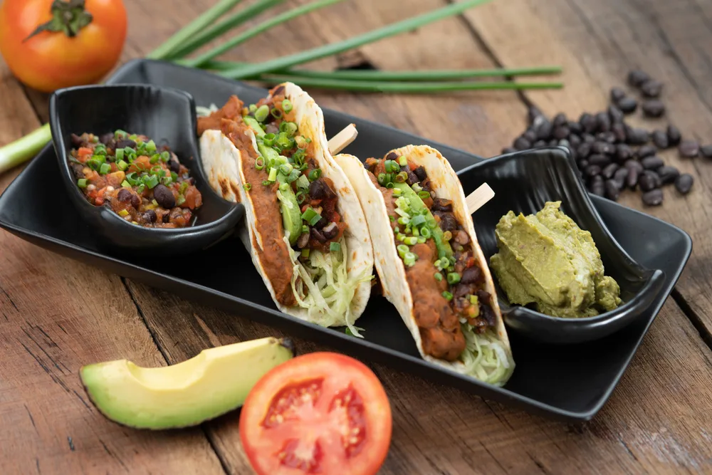 Baked tortillas with black beans, tomato, cilantro, red onion, avocado and assorted spices served with avocado dip on the side