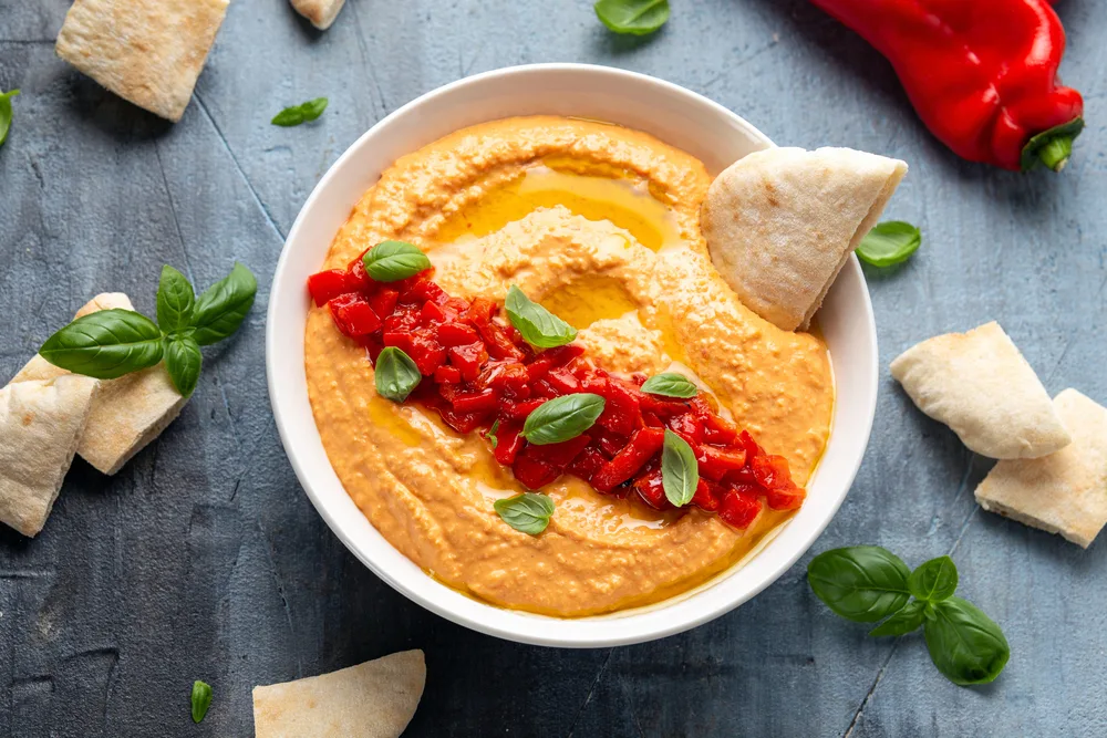 Roasted red pepper hummus with pita bread. Healthy food.