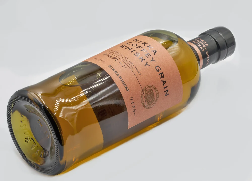 Kyiv, Ukraine - November 06, 2011: Japan Nikka Coffey Grain whisky bottle closeup on white. It is a producer of Japanese whisky and other beverages headquartered in Tokyo.