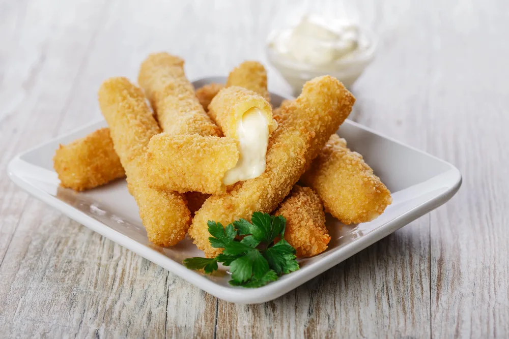 Fried mozzarella cheese sticks breaded — Photo