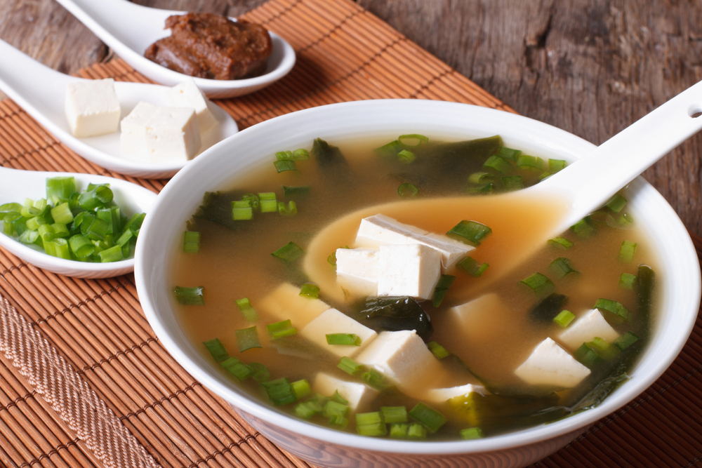 Japanese miso soup in bowl with a spoon vertical — Photo