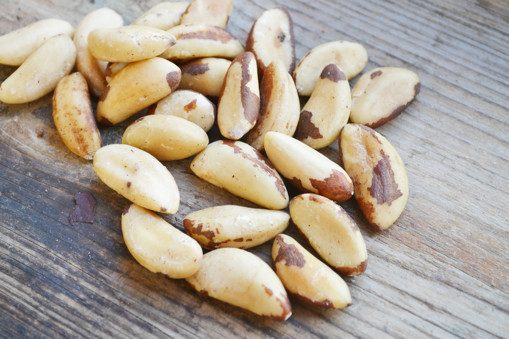 Bunch of Brazil nuts on wooden table — Photo