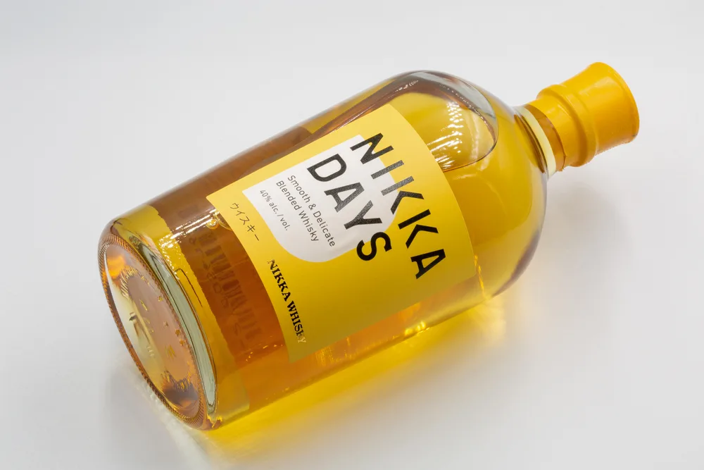 Kyiv, Ukraine - October 20, 2022: Japanese Nikka Days blended whisky bottle closeup on white. It is a producer of Japanese whisky and other beverages headquartered in Tokyo.