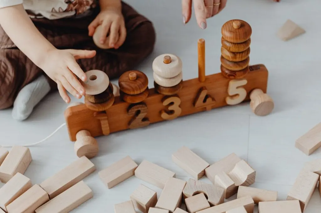 A child playing with a wood Montessori counting toy learning about numbers
