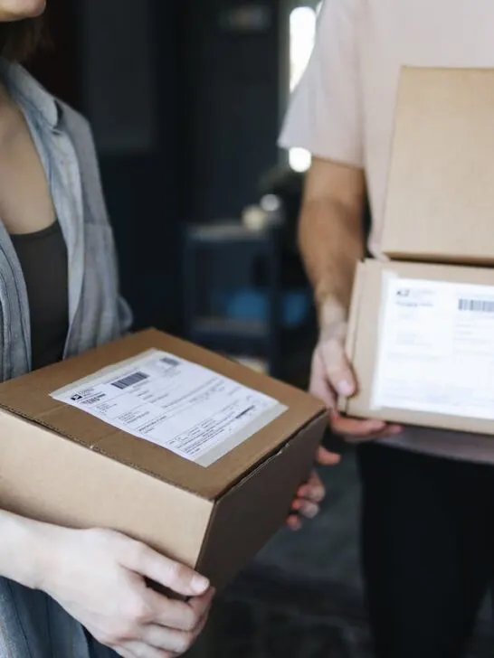 Two people holding packages to ship using virtual address services to simpilfy the process