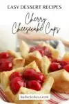 Finished cherry cheesecake cups laid out on a red and white striped plate
