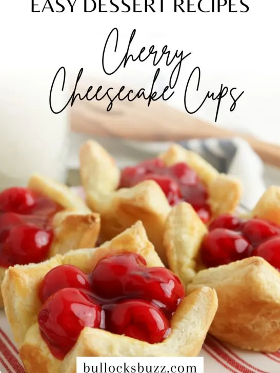 Finished cherry cheesecake cups laid out on a red and white striped plate