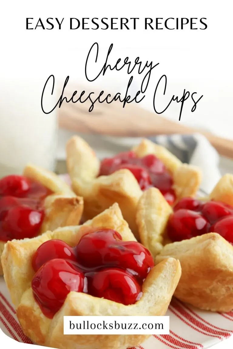 Finished cherry cheesecake cups laid out on a red and white striped plate