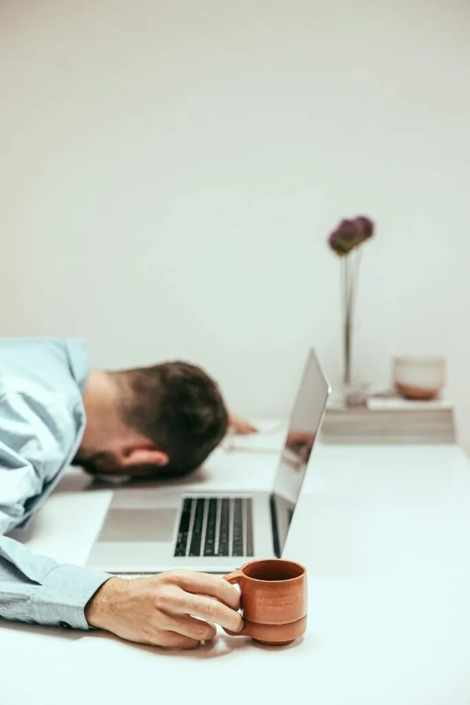 A man asleep at his desk