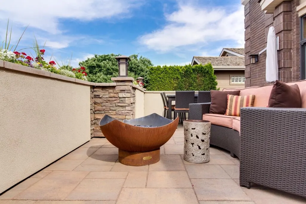 A patio with firepit and couch transforms a patio into an outdoor living space