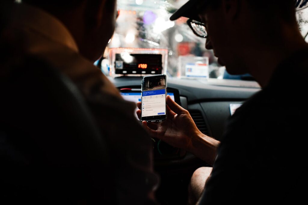 Two people looking at an app to schedule a rideshare