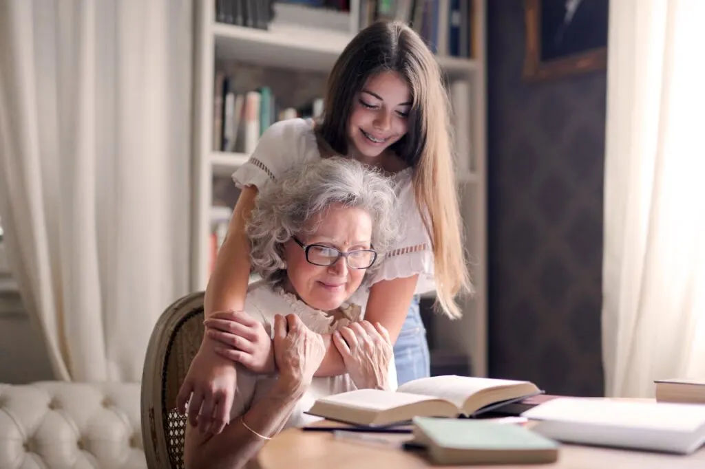 A young girl working with her grandmother on reading