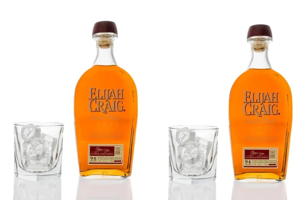 Winneconne, WI - 20 March 2020: A bottle of Elijah Craig Kentucky straight bourbon whiskey with a glass of ice on an isolated background. — Photo by homank76