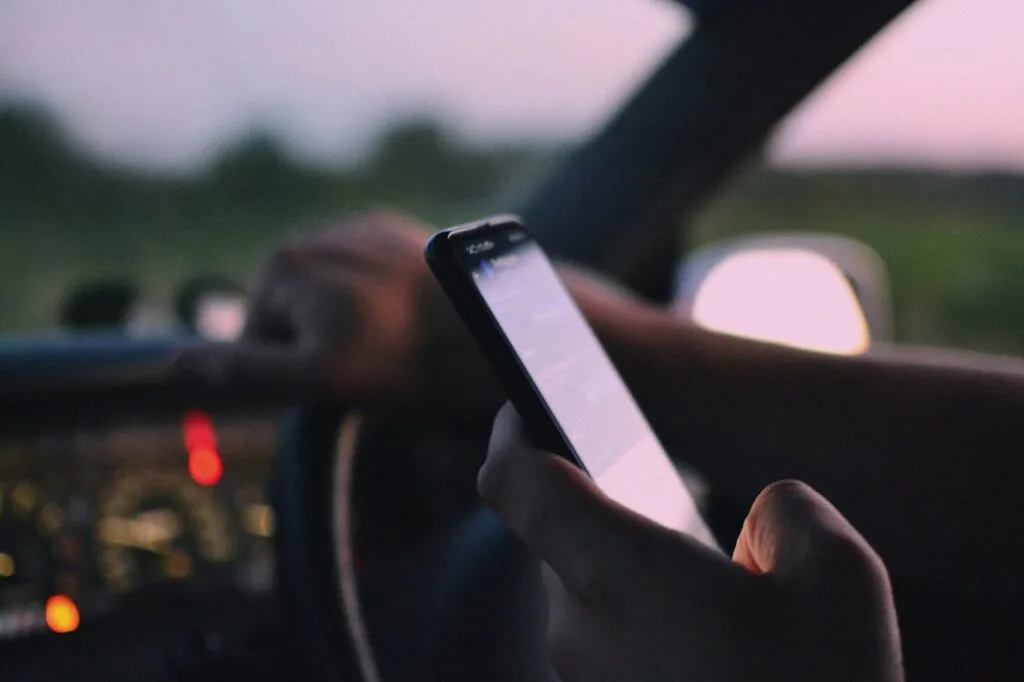 Close up of a person texting and driving