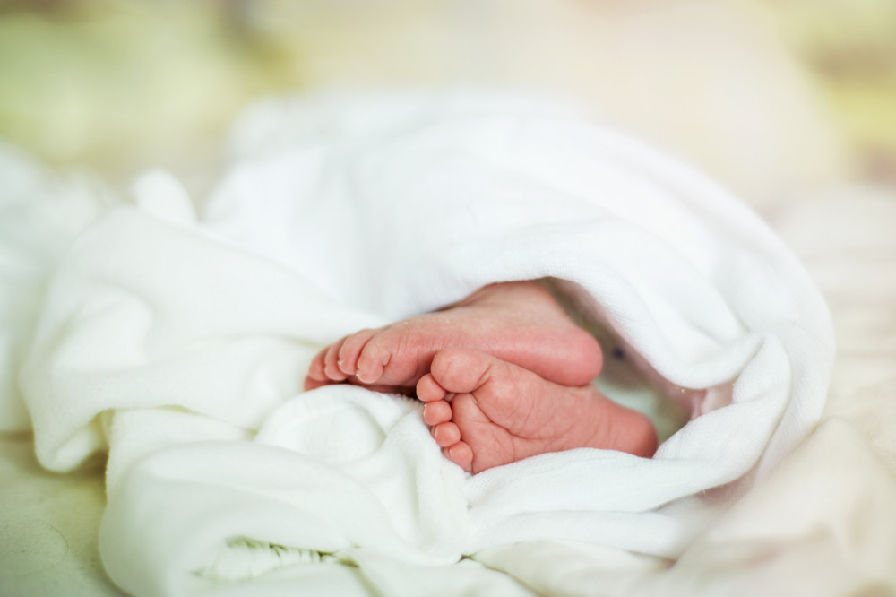 Close up image of a newborn baby girl’s feet.