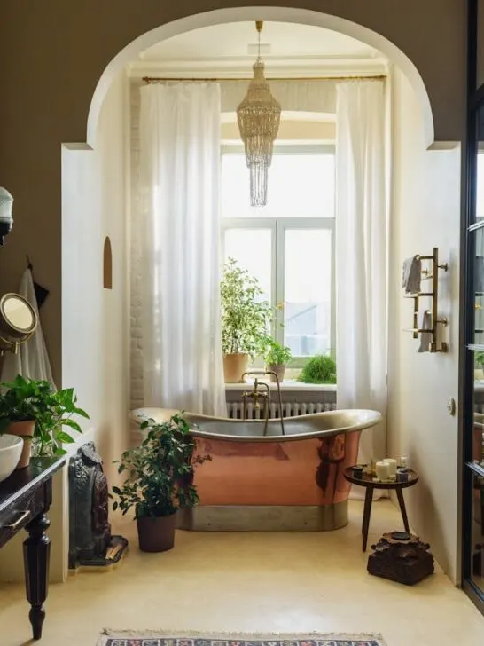 A gorgeous bathroom with a copper soaking tub, vessel sinks, and lots of natural light. Here are some tips on how you can create a luxurious retreat at home.