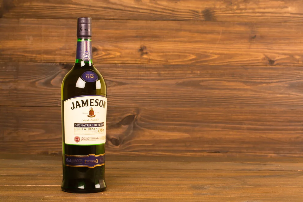 READING MOLDOVA APRIL 8, 2016. One bottle of Jameson Whiskey Triple Distilled 40% 1 Liter on black background. Blended whiskey is imported from Ireland — Photo by kizer13