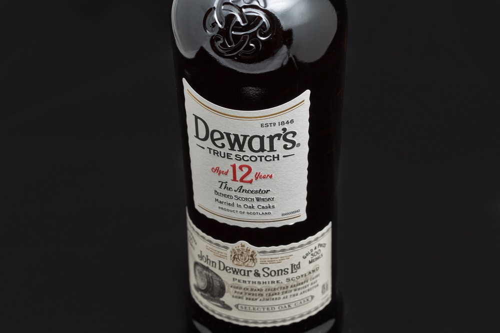 KYIV, UKRAINE - AUGUST 17, 2019: Dewar's True Scotch The Ancestor aged 12 years blended Scotch Whisky label closeup. Dewar's whiskies have won more than 400 awards and medals in over 20 countries. — Photo by panama7