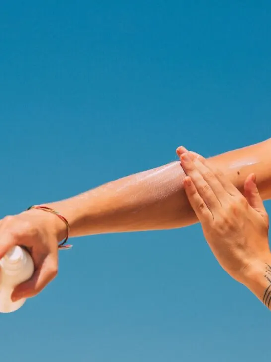 A woman adding sunscreen to her arm, one of the best ways to address Skin Concerns with the Right Treatment