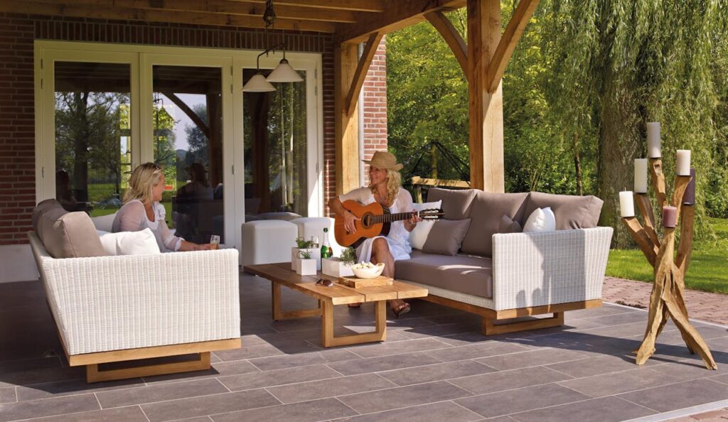 Creating an outdoor living space like this one with couches and tables is a big home improvement that can pay off in the long run