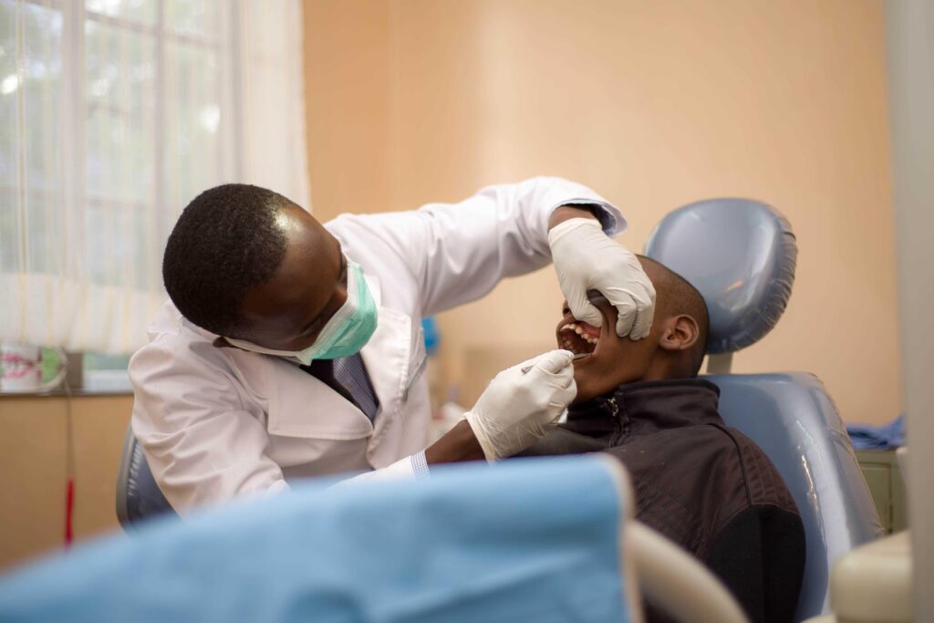 A dentist looking in a man's mouth