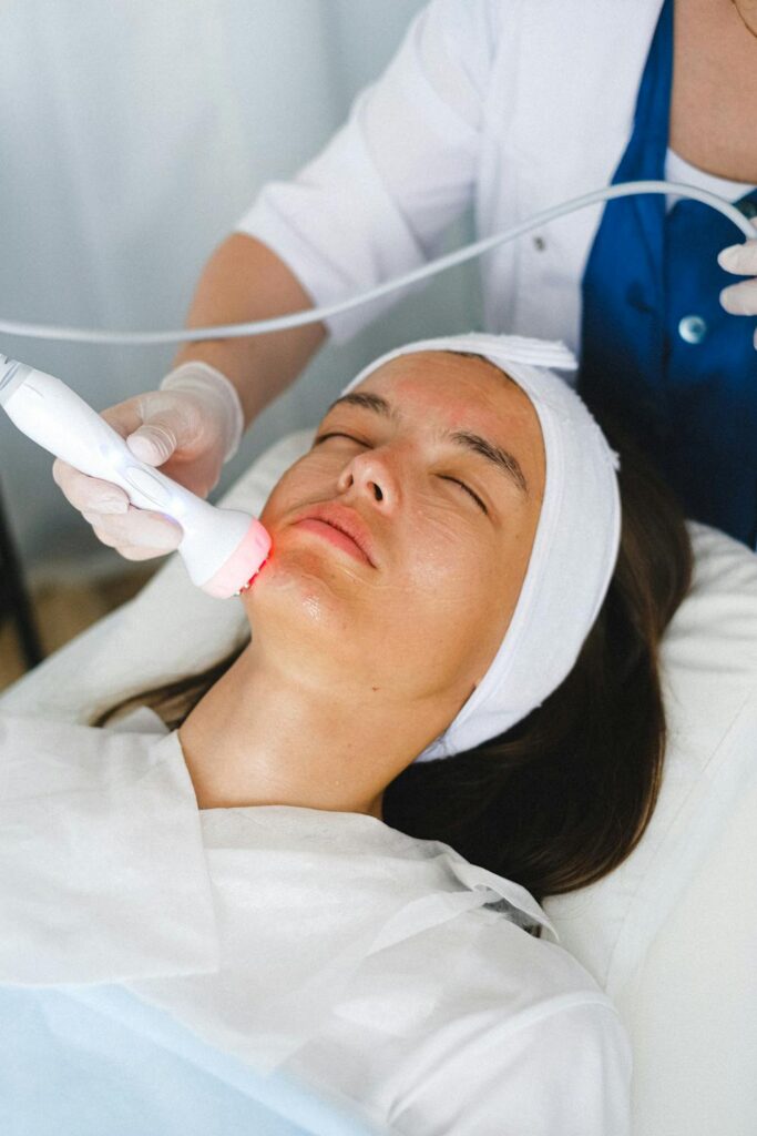 A woman getting red light therapy on her face