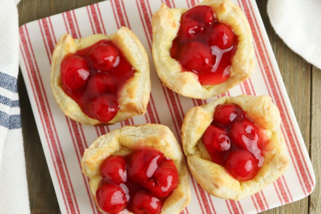 Cherry Cheesecake Cups on a red and white striped plates are a super easy Homemade Valentine's Treats