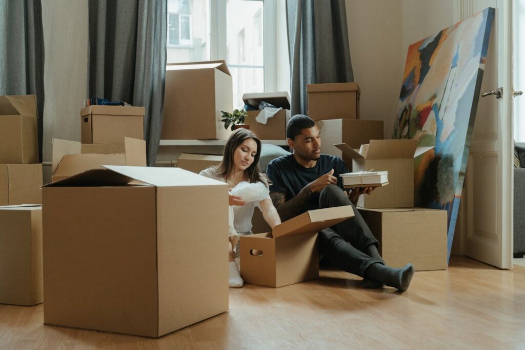 A man and woman packing their belongings to move after making sure they knew how to choose the right moving company.