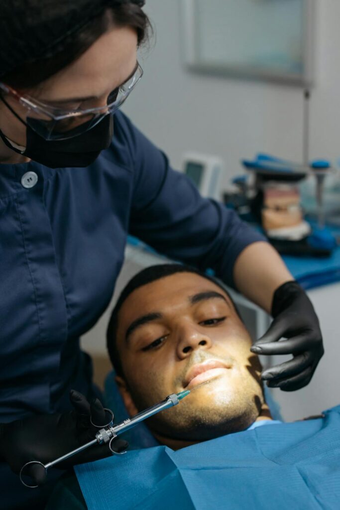 A man in a dentists chair about to have his teeth checked and cleaned