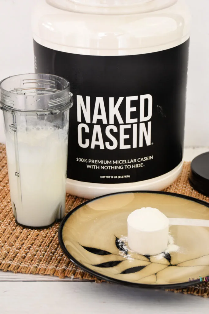 A cup filled with casein mixed with water. It looks like white milk.