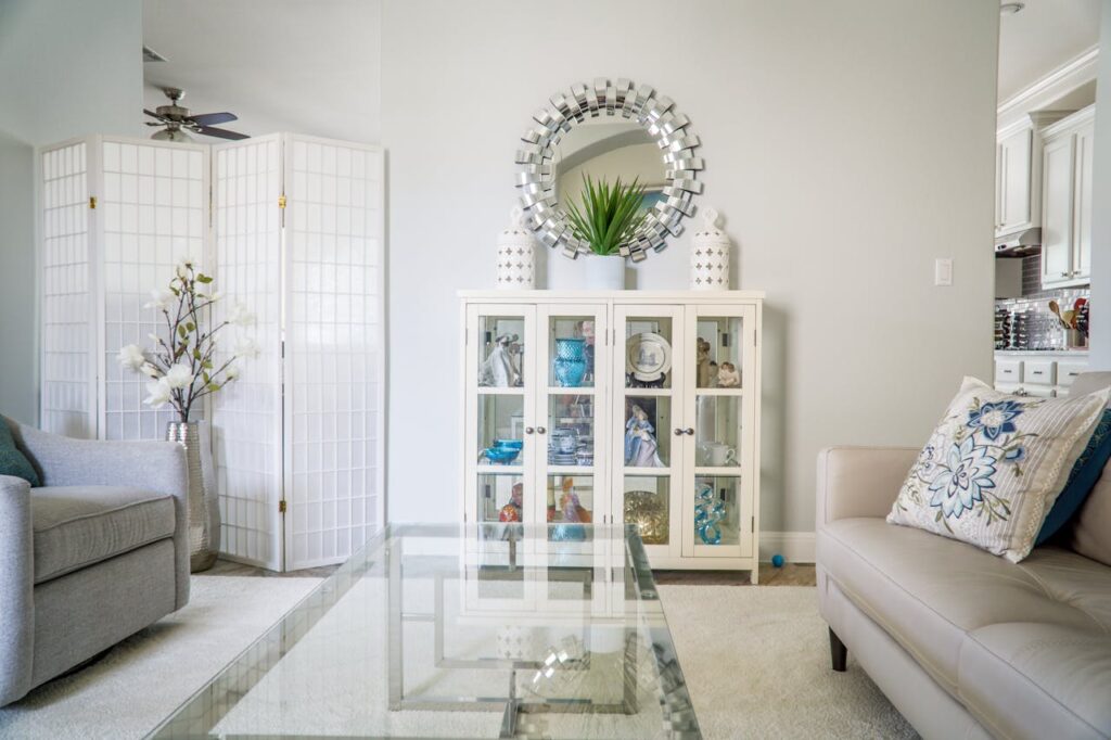 A beige living room with a Japanese screen and a mirror on the wall