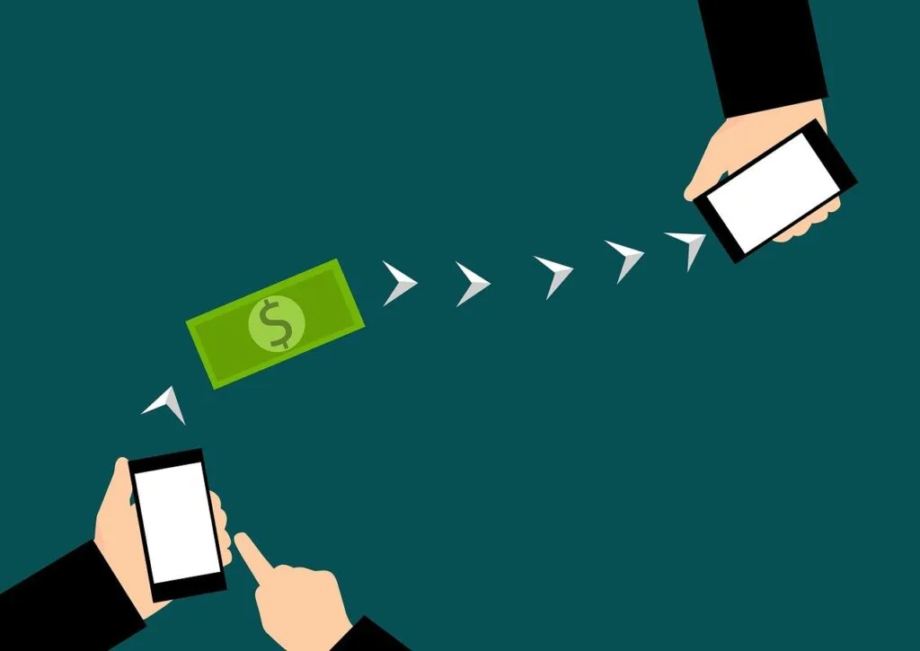 A graphic showing a dollar bill in between two cell phones representing sending money online